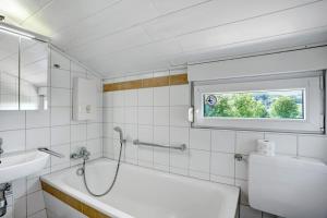 a bathroom with a tub and a toilet and a sink at Ferienhaus Bianca in Meschede +31 photos