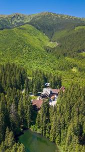 an aerial view of a house in the middle of a mountain at Hotel Mikulášska Chata in Belá +77 photos
