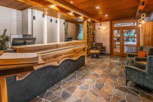 a lobby with a bar with a stone floor at Hotel Mikulášska Chata in Belá
