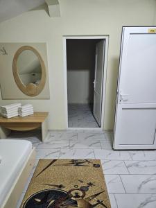 a bathroom with a mirror and a rug on the floor at Casa Andreea in Eforie Sud +59 photos