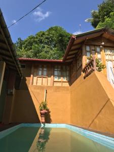 a house with a swimming pool in front of a house at Plantation Retreat in Matale