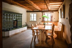 a dining room with a wooden table and chairs at Berghof Papstdorf in Kurort Gohrisch