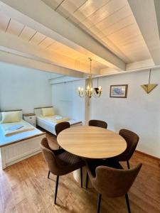 a dining room with a table and chairs and a bed at APARTMENT Alessio in Interlaken +19 photos