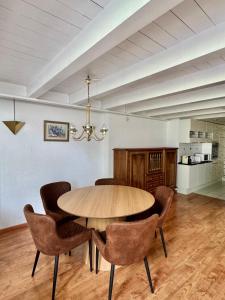 a dining room with a wooden table and chairs at APARTMENT Alessio in Interlaken