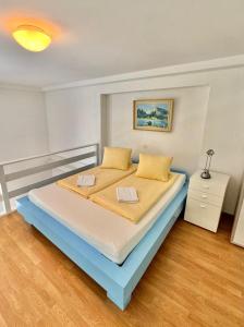 a bedroom with a large bed with yellow pillows at APARTMENT Alessio in Interlaken