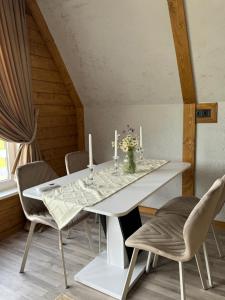 a dining room with a white table and chairs at lovelaz820 in Khashchovanoye +8 photos