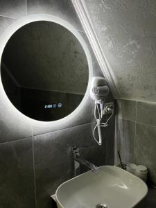 a bathroom with a round mirror and a sink at lovelaz820 in Khashchovanoye