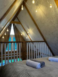 a bedroom with a bed in a attic at lovelaz820 in Khashchovanoye