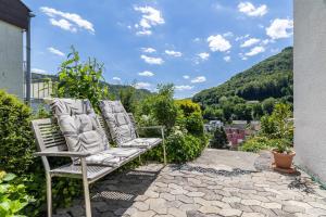 a pair of chairs sitting on a patio with a view at Panoramablick Loft & Aktiv-Urlaub in Lichtenstein