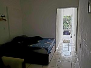 a bedroom with two beds in a room with a doorway at Kitnet Unip Mandic in Campinas