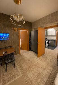 a dining room with a table and a refrigerator at Royal Fsm Suites in Istanbul