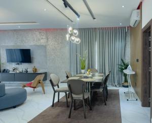 a living room with a dining room table and chairs at Luxury Executive Balcony Suite at THE HIDDEN DOMUS I Elmina Suite in Accra