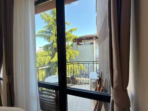 a room with a window with a view of a balcony at Adeti Residence in Nesebar +108 photos