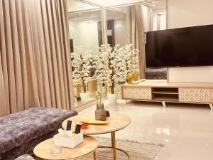 a living room with a large television and a couch at نزل vip in Al Yamāmah