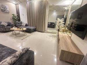 a living room with a couch and a table at نزل vip in Al Yamāmah