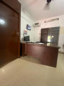 an office with a desk and a door in a room at Tech City Hotel Trivandrum in Trivandrum