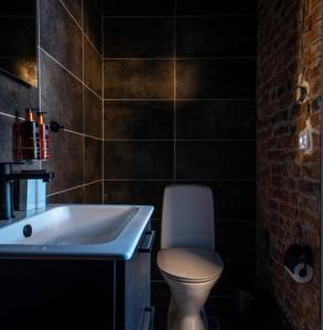 a bathroom with a white toilet and a bath tub at Kronan Bed & Breakfast in Vara