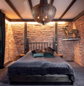 a bedroom with a bed in a brick wall at Kronan Bed & Breakfast in Vara
