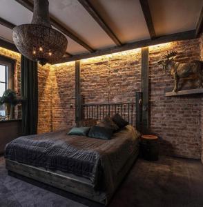 a bedroom with a bed in a brick wall at Kronan Bed & Breakfast in Vara