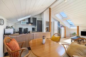 a kitchen with a wooden table and chairs at Panoramablick Loft & Aktiv-Urlaub in Lichtenstein