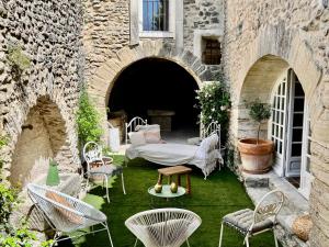 a patio with chairs and a table in a building at La Villa 1777 in Lagnes