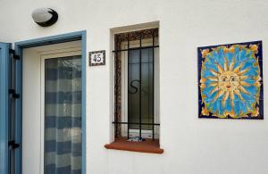 a building with a window with a sun on it at Victoria House Scopello in Scopello
