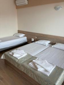 two beds sitting next to each other in a room at Cattleya in Nesebar +2 photos