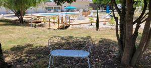 a chair sitting in the grass next to a pool at Suite Millésime du Château - Proche Océan in Gaillan-en-Médoc
