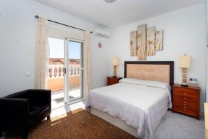 a white bedroom with a bed and a balcony at CH Logroño Doña Pepa in Rojales +29 photos