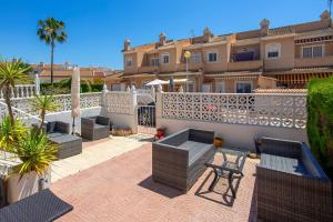 a patio with benches and a fence in front of a building at CH Logroño Doña Pepa in Rojales