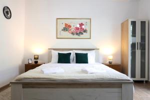 a bedroom with a large bed with two pillows at Doricera in Kotor
