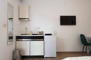 a small kitchen with a sink and a microwave at Doricera in Kotor +21 photos
