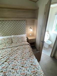 a bedroom with a bed and a bathroom with a window at Beauport Retreat in Hastings