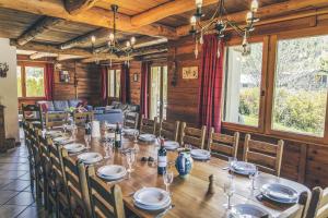 a long dining room with a long table and chairs at Chalet Le Serre des Oiseaux in Saint-Chaffrey +19 photos