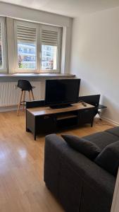 a living room with a couch and a flat screen tv at Boismortier in Thionville
