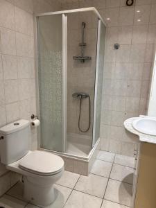 a bathroom with a shower and a toilet and a sink at Boismortier in Thionville