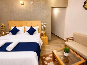 a hotel room with a bed and a couch at The Hills Boho in Mukteshwar