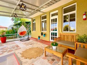 a porch with a bench and a swing at The Hills Boho in Mukteshwar