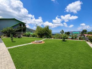 a lawn with a fountain in the middle of a yard at The Hills Boho in Mukteshwar