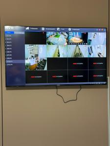 a television hanging on a wall with a website at Kol-Ukok Hotel in Bol'shevik