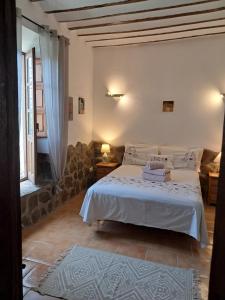 a bedroom with a white bed and a couch at Cortijo Esquina B&B Guesthouse in Arboleas