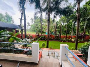 a view of a park with palm trees at Hotel 14 Pods Morjim in Morjim