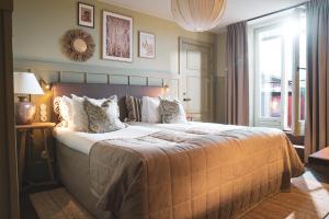 a large bed in a room with a window at Fågelbro Säteri in Värmdö +54 photos