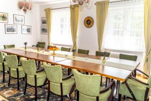a dining room with a long table and chairs at Vila Vlasta in Bruntál