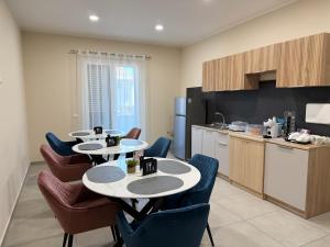 a kitchen with four tables and chairs in a kitchen at Volare B&B in Reggio di Calabria
