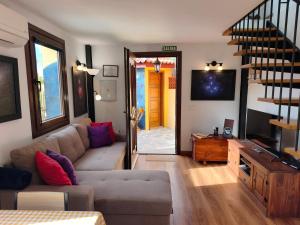a living room with a couch and a sliding glass door at Los Nacientes Vega in Los Sauces