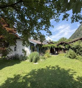 a house with a yard in front of it at Chiemgau One in Marquartstein
