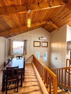 a dining room with a table and wooden ceilings at Chalet Duplex N 6 avec piscine in Bouzareah