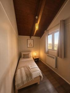 a bedroom with a bed and a window at Chalet Duplex N 6 avec piscine in Bouzareah +14 photos