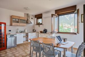 a kitchen with a table with a laptop on it at Meridiana Gemona in Taboga